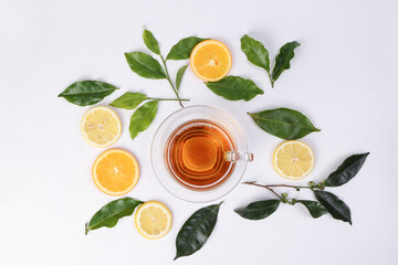 different types of fresh raw green tea leaf flower bud lemon orange slice transparent glass teacup...