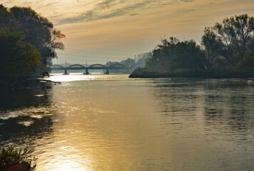 Autumn scenery along the Grand River with sunrise view of the historic bridge in Caledonia, Ontario Canada