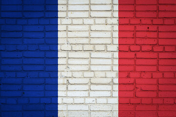 National flag of France depicting in paint colors on an old brick wall. Flag  banner on brick wall background.