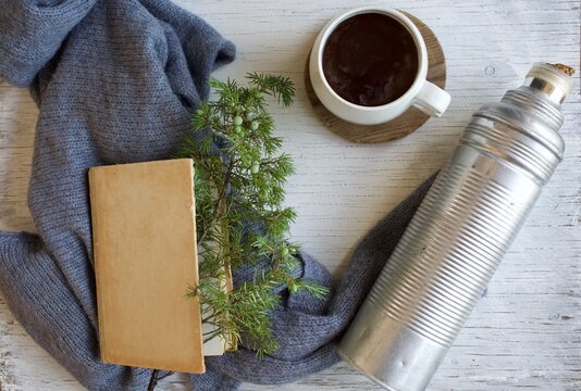 Flat lay image of thermos bottle, book and tea cup. Autumn mood.
