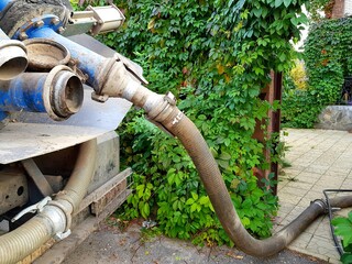 Image of units of a pumping machine for pumping out a septic tank. Sewerage in a private house.