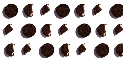Chocolate sweet cookies consisting of two crumbly parts and a creamy layer in the middle. Round chocolate cookie pattern on a white isolated background. A banner with the cookies whole and bitten.