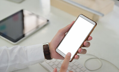 Close-up shot of Hand using blank screen smartphone mockup.