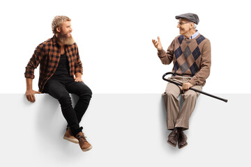 Elderly man talking to a bearded guy and sitting on a white panel