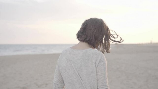 Beautiful happy Woman walking on the beach towards sunset, 1080p 50fps slog 2