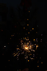 Sparks from a sparkler on a dark background