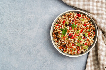 Bulgur pilaf with eggplant and vegetables. Top view with copy space