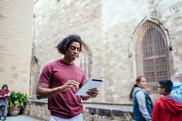 Focused black man browsing map app on tablet