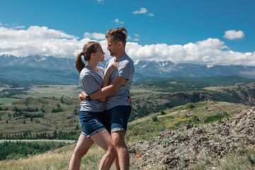 Loving couple together on Altai mountain looking at a view