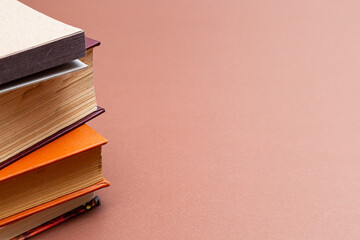 Stack of books on a beige background. Vintage books with copy space