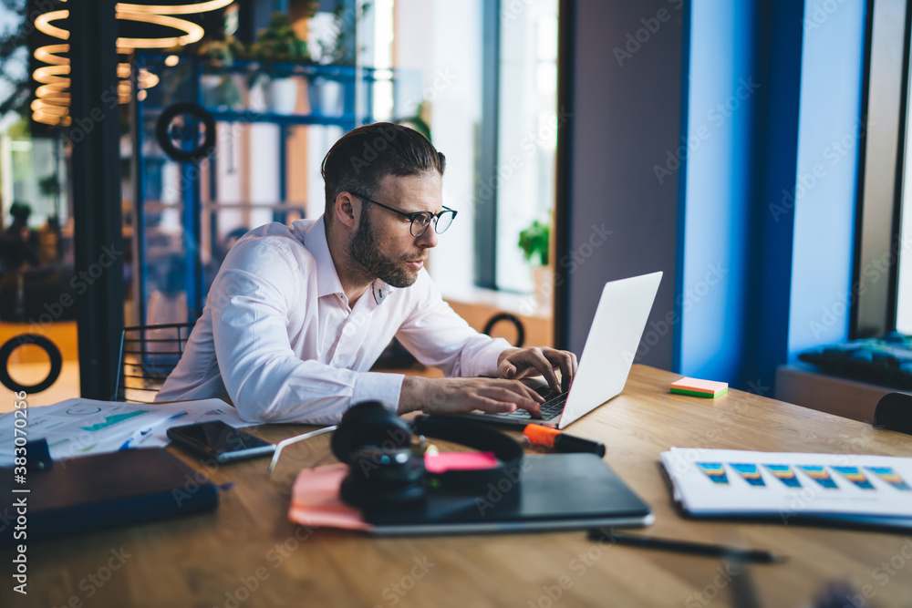 Poster caucasian office worker in classic spectacles browsing banking website for making web booking, skill