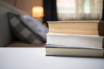 books on bedroom table by bed
