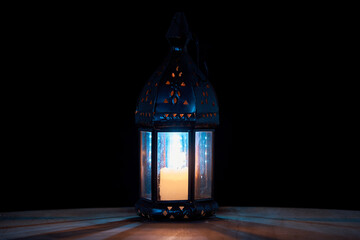 Night scene with vintage lamp and hands. Candle, magic, witchcraft and mysticism. Halloween holiday concept