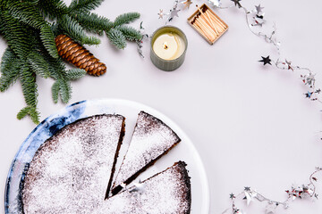 Fototapeta na wymiar Homemade chocolate brownie almond cake on grey background. Gluten free flourless dessert. Winter christmas treat