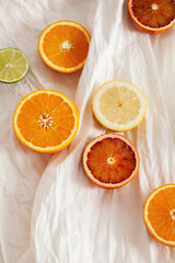 Lime, lemon and orange slices on white background