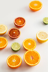 Lime, lemon and orange slices on white background