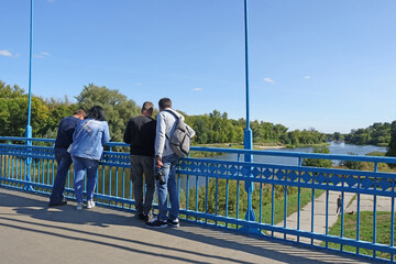 People on the Pedestrian Tezikovo Bridge over the Tsna River in Tambov.