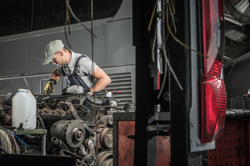Fototapeta na wymiar Automotive Technician Restoring Old Diesel Engine