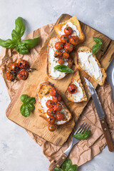 Tasty tapas, snack or crostini or Bruschetta with toasted baguette, roasted tomatoes. Delicious breakfast, snack, appetizers