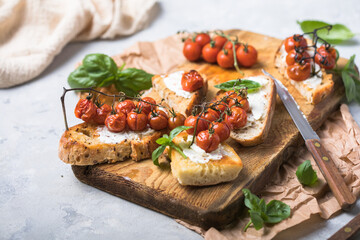 Tasty tapas, snack or crostini or Bruschetta with toasted baguette, roasted tomatoes. Delicious breakfast, snack, appetizers