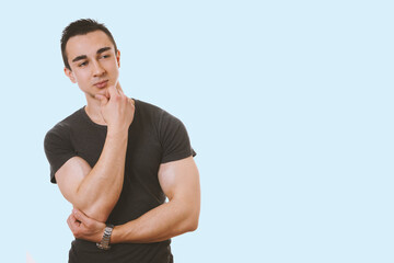 muscular young man contemplating an idea. with copy space.