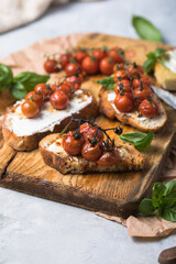 Tasty tapas, snack or crostini or Bruschetta with toasted baguette, roasted tomatoes. Delicious breakfast, snack, appetizers