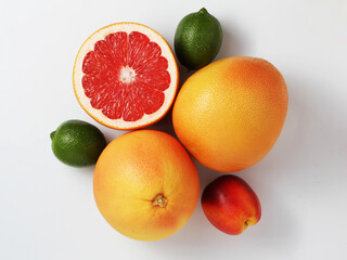 Fresh fruit mix on a white background. Grapefruit, lime, nectarine. Top view