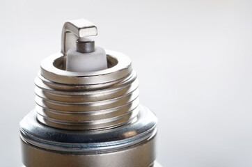 Closeup photo of new spark plug for internal combustion engine on metal background. Space for text
