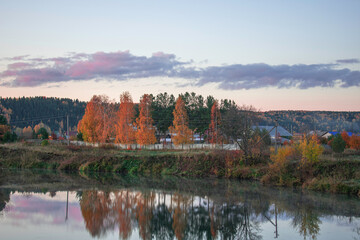 Bright dawn in the village by the river