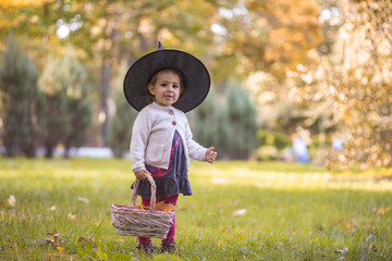 Kids trick or treat on Halloween night. Little girl with pumpkin face candy bucket. Child trick or...