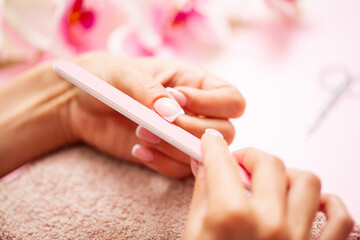 Woman close up doing manicure at home