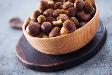 wooden bowl full of fresh mushrooms