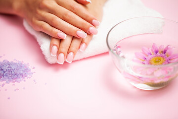 Young woman after getting professional manicure in beauty salon