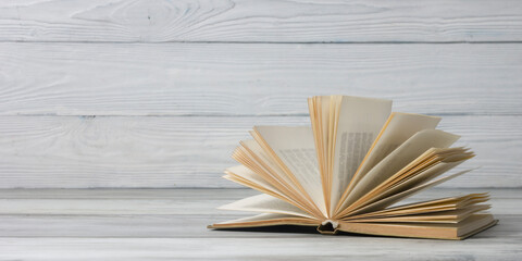 Open book, hardback books on wooden table. Back to school. Copy space