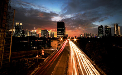 Fototapeta na wymiar Light trails on the busy street at sunset in Jakarta, Indonesia 