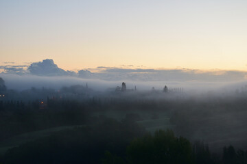 village in the fog in Tuscany