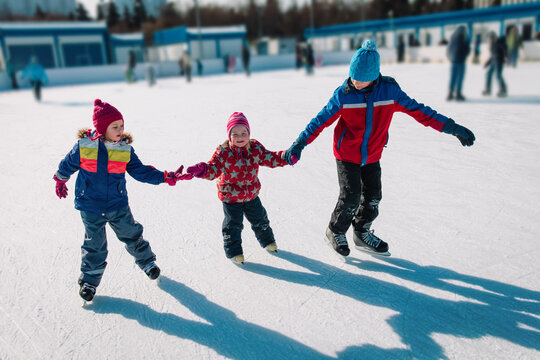 Happy Kids Skating In Winter Nature, Family Winter Sport