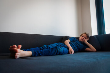 kid bored and tired at home, boy stressed and exhausted