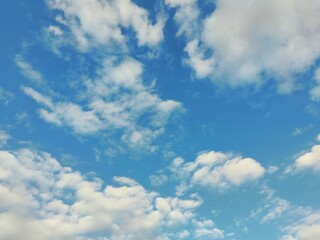 texture of blue autumn sky with delicate white clouds