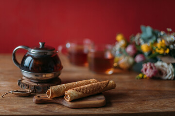 Still life. A table with a teapot, mugs and flowers