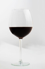A glass of red wine on a white background.