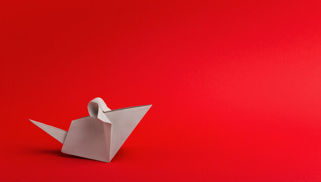 Origami of rat for Chinese New Year on bright red background