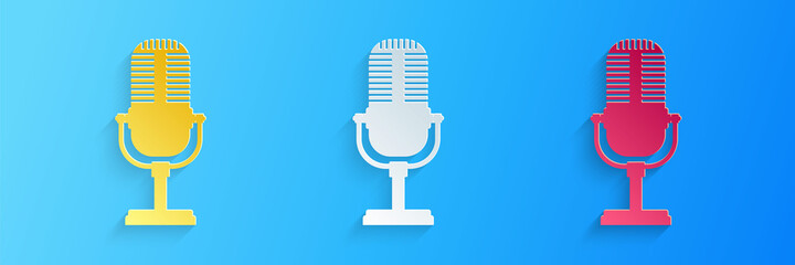 Paper cut Microphone icon isolated on blue background. On air radio mic microphone. Speaker sign. Paper art style. Vector.