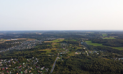 Beautiful top view of the forest and suburb with houses and a park