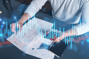 Multi exposure of man signing contract with phone and forex chart hologram. Concept of financial...