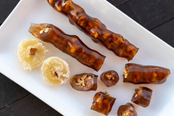 Cevizli sucuk made by dipping a string with walnuts into a grape molasses mixture. Churchkhela, Pestil, Cevizli Sucuk, Walnut sausage