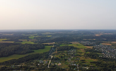 Beautiful top view of the forest and suburb with houses and a park