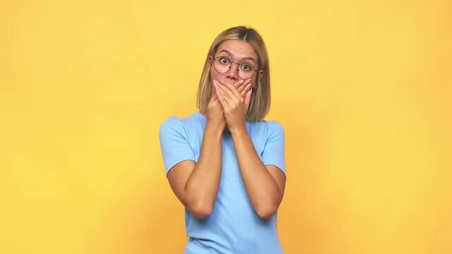 Young blonde caucasian woman shocked covering mouth with hands
