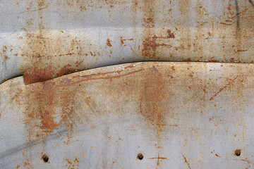 Old metal surface for the backdrop. Silver paint. Horizontal crack. Rusty screws.