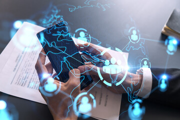 Businessman using on-line app on phone. social network icons hologram. Multiexposure. People connection concept.